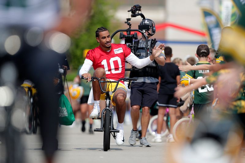 Green Bay Packers quarterback Jordan Love (10) participates in the Dream Drive bicycle ride on the third day of training camp July 25, 2025, in Green Bay, Wis.