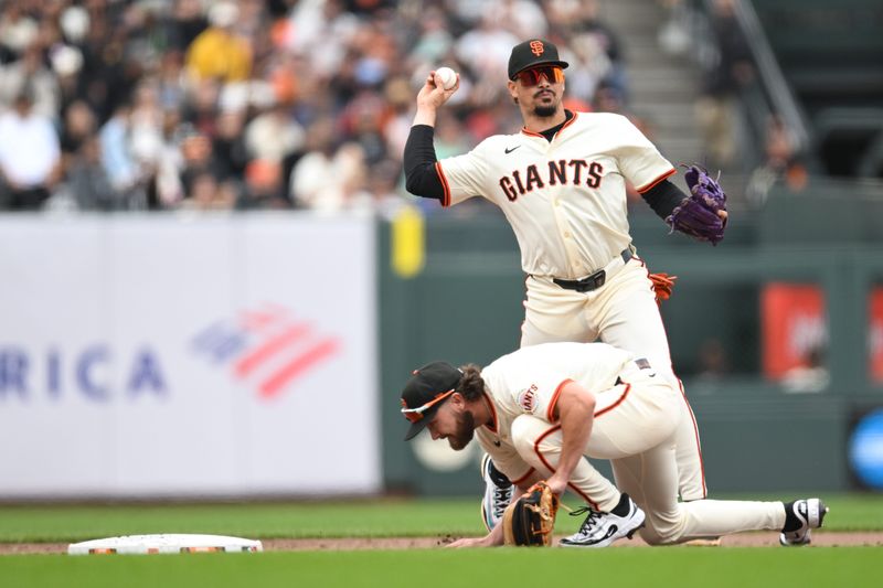 Jul 30, 2025; San Francisco, California, USA; San Francisco Giants shortstop Willy Adames (2) throws to first base for an out over second baseman Brett Wisely (0) against the Pittsburgh Pirates in the tenth inning at Oracle Park.