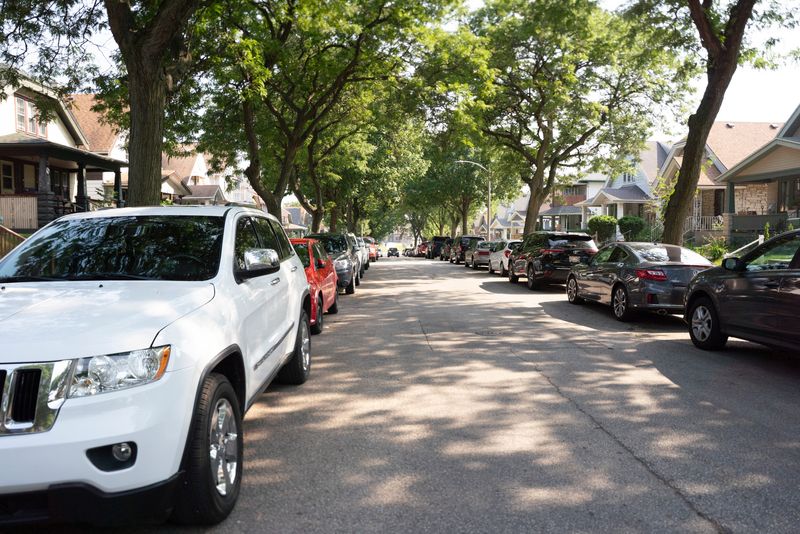 Cars park on both sides of South 33rd Street in Burnham Park in Milwaukee on Aug. 1, 2025. Neighbors often struggle to find a parking space because of limited parking availability and sometimes have to park in their own yards or illegally.