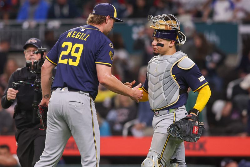 Aug 4, 2025; Atlanta, Georgia, USA; Milwaukee Brewers relief pitcher Trevor Megill (29) and catcher William Contreras (24) celebrate after a victory over the Atlanta Braves in the ninth inning at Truist Park. Mandatory Credit: Brett Davis-Imagn Images