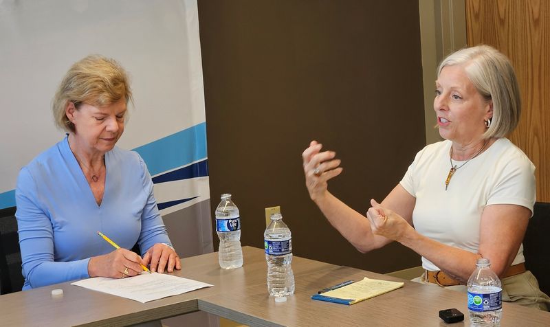 U.S. Sen. Tammy Baldwin, left, takes notes as Medicaid advocate Julie Burish talks about the effect Medicaid cuts would have on her family and others during an Aug. 8, 2025, roundtable on the cuts held by Baldwin at Door County Medical Center in Sturgeon Bay, Wis.