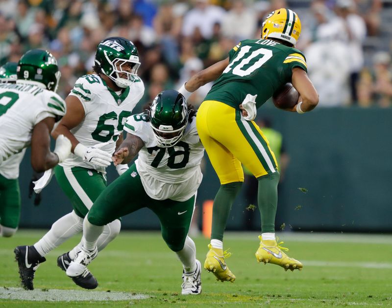 New York Jets defensive tackle Jay Tufele sacks Green Bay Packers quarterback Jordan Love.