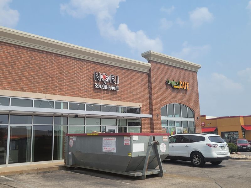 A sign on Johnson Street shows Nori Sushi & Grill preparing to open next to Tropical Smoothie Cafe.