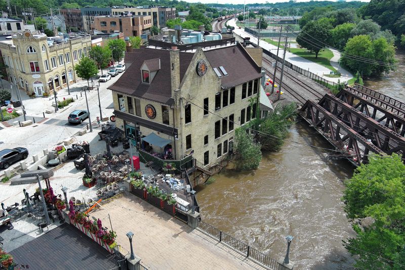 The pedestrian walkway over the Menomonee River near Cafe Hollander is closed on Monday, Aug. 11, 2025. The river was still well above its banks Monday after heavy rainfall led to flooding across the Milwaukee area over the weekend.