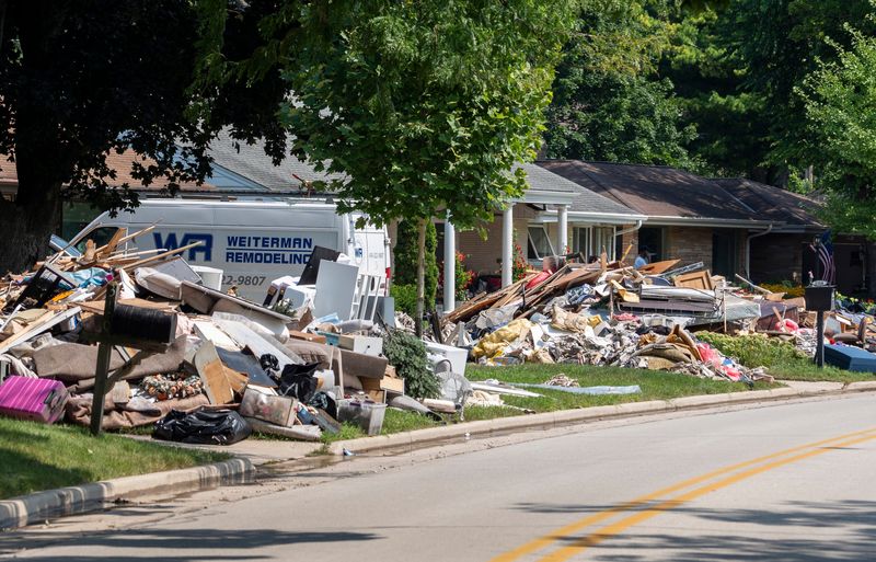 Residents place flood damaged belongings on the curb of Menomonee River Pkwy on Thursday August 14, 2025 in Wauwatosa, WI. The flooding was caused by a severe storm that swept through the region Aug. 9-10, causing significant water accumulation and damage.