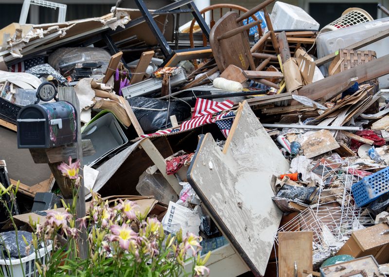 Residents place flood damaged belongings on the curb of Menomonee River Pkwy on Thursday August 14, 2025 in Wauwatosa, WI. The flooding was caused by a severe storm that swept through the region Aug. 9-10, causing significant water accumulation and damage.