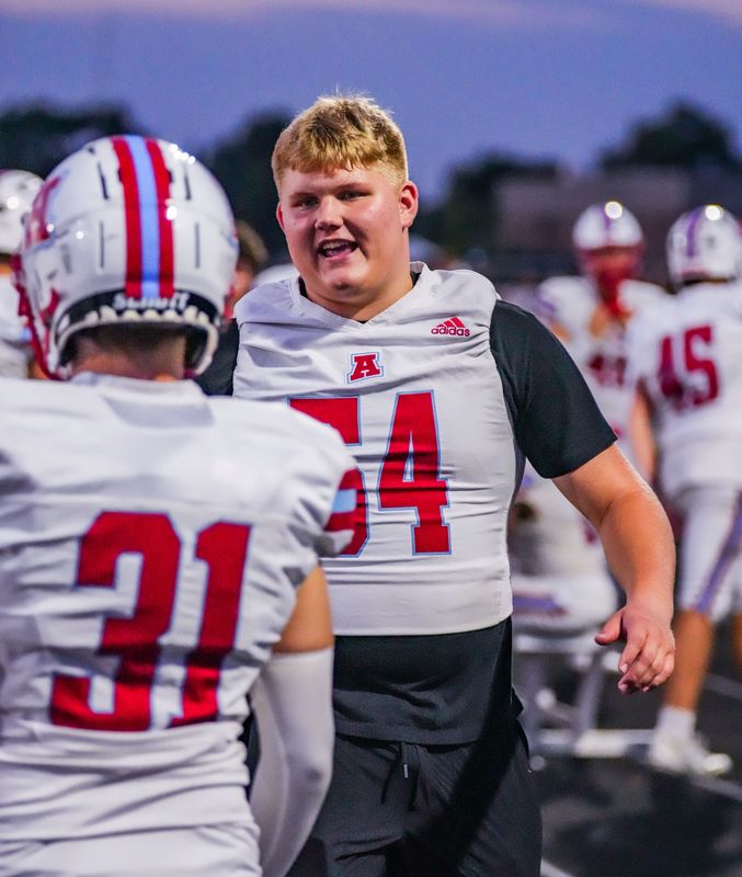 Arrowhead's Tristen Seidl (54) encourages his teammates on the sideline during the nonconference season opener against Marquette at Menomonee Falls on Friday, August 22, 2025. Seidl is sidelined this week due to an ongoing WIAA waiver issue.