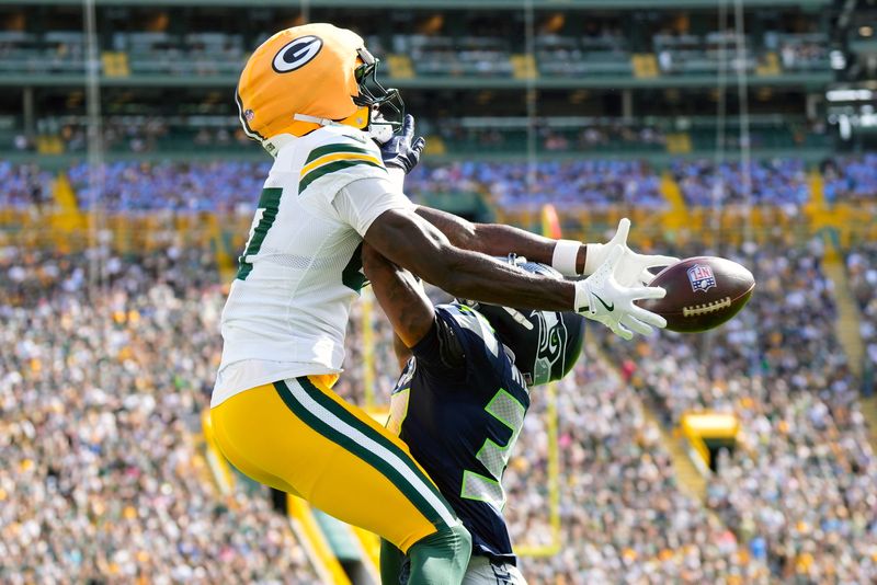 Seattle Seahawks cornerback Damarion Williams (37) commits a pass interference penalty as Green Bay Packers wide receiver Romeo Doubs (87) tries to catch a pass.