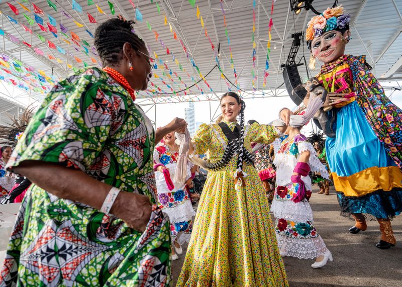 Baile folklórico performers dance with (left) Congresswoman Gwen Moore (D‑WI) during the opening ceremony of the 52nd Annual Mexican Fiesta on Friday August 22, 2025 at the Henry Maier Festival Park in Milwaukee, WI.