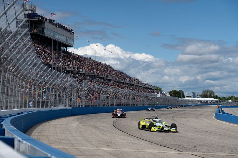 Christian Rasmussen in the No. 21 Ed Carpenter Racing Chevrolet leads a line of racers through turn one during the Snap-On Milwaukee Mile 250 in West Allis on the afternoon of Aug. 24, 2025.