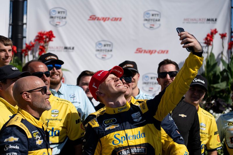 Christian Rasmussen snaps a selfie on the podium after scoring his first NTT IndyCar Series win in 2025 at the Milwaukee Mile.