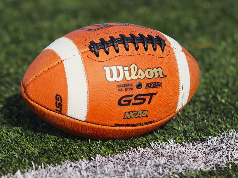 A football pictured lying on the turf at Bridgewater-Raynham Regional High School's football field in Bridgewater, MA on Aug. 19, 2025.