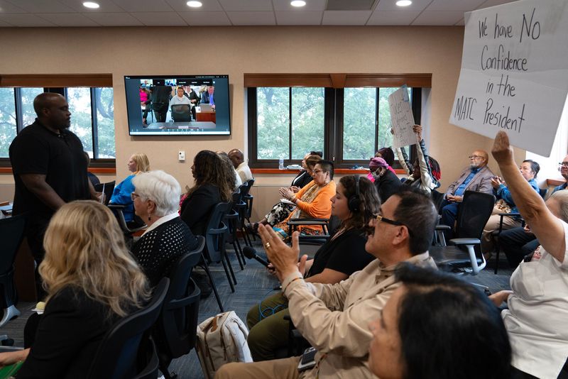 Community members clap and cheer in support of Floyd C. Griffin III, who lost his job in the former Office of Multicultural Services, after speaking during public comment of a board meeting at the Milwaukee Area Technical College downtown campus in Milwaukee on Aug. 26.