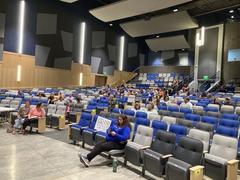 MacArthur Elementary parents sit and wait for the Germantown School Board to get out of a closed session meeting Aug. 26, 2025. The meeting was held in Germantown High School's Performing Arts Center.