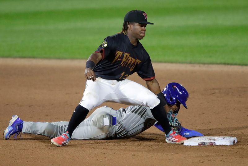 Quad Cities River Bandits' Eridk Torres (4) gets back to second base safely against Wisconsin Timber Rattlers' Jesus Made (12) Wednesday, August 27, 2025, at Neuroscience Group Field at Fox Cities Stadium in Grand Chute, Wisconsin. Quad City won 9-5.
