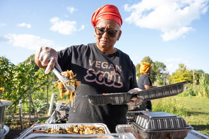 Chef “Mama” Zakiya Courtney, the owner of Vegan Soul, places greens onto a plate at Alice’s Garden on Aug. 26, 2025, in Milwaukee, Wisconsin. Courtney says she now drives to Wauwatosa when she needs groceries after the Pick ’n Save closed in Metcalfe Park. -Angelica Edwards/ The Milwaukee Journal Sentinel