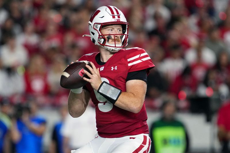 Aug 28, 2025; Madison, Wisconsin, USA; Wisconsin Badgers quarterback Billy Edwards Jr. (9) looks to throw a pass during the second quarter against the Miami (OH) RedHawks at Camp Randall Stadium. Mandatory Credit: Jeff Hanisch-Imagn Images