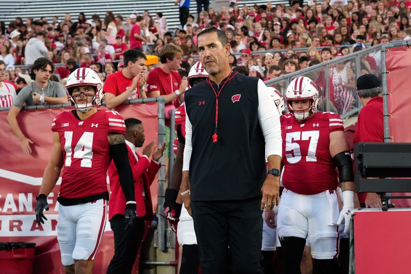 Aug 28, 2025; Madison, Wisconsin, USA; Wisconsin Badgers head coach Luke Fickell walks onto the field for warmups prior to the game against the Miami (OH) RedHawks at Camp Randall Stadium. Mandatory Credit: Jeff Hanisch-Imagn Images