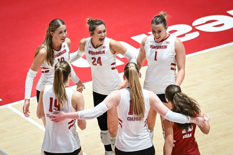 Wisconsin players Madison Quest (10), Charlie Fuerbringer (24), Ana Vajagic (1), Maile Chan (18), Mimi Colyer (15) and Tosia Serafinowska (19) celebrate match point against Marquette in a spring match Wednesday, April 16, 2025, at the UW Field House in Madison, Wisconsin.