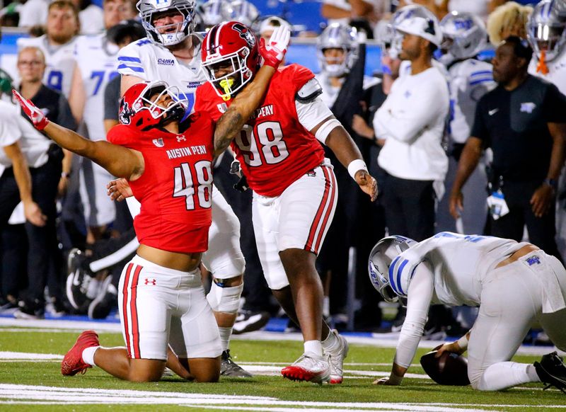 Austin Peay defensive lineman Joquarri Price (48) celebrates sacking Middle Tennessee quarterback Nicholas Vattiato (11) with Austin Peay defensive lineman Charles Crews III (98) during MTSU's first home football game of the season against Austin Peay, on Saturday, Aug. 30, 2025.
