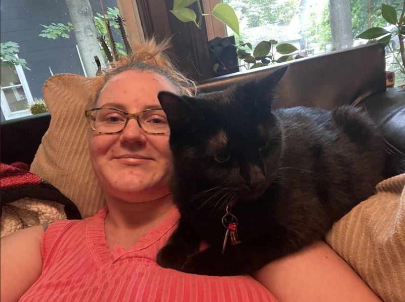 Ashlee Crosno's emotional support cat, Ruthless, relieves her anxiety by lying on her chest.
