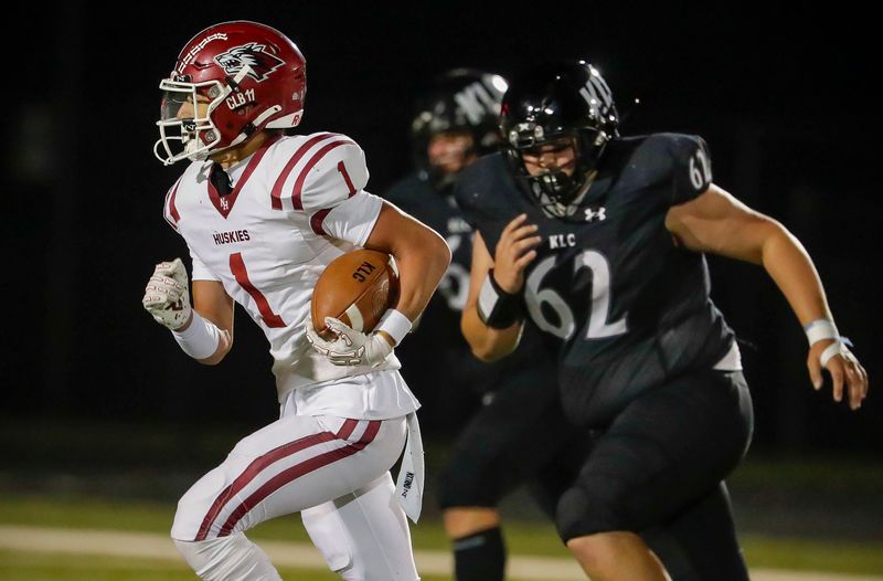 New Holstein’s Ely Kohlman (1) carries the ball by Kohler/Lutheran/Christian’s Ayden Wildman (62), Thursday, September 4, 2025, in Kohler, Wis.