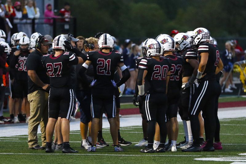 Fond du Lac huddles during a timeout during its game against Appleton North at Fond du Lac's Cardinal Stadium on Thursday, Sept. 4, 2025.