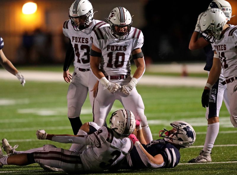 Fox Valley Lutheran's Jack Schlueter (10) celebrates a stop for the Foxes defense against Xavier during a game Sept. 5 at Xavier.