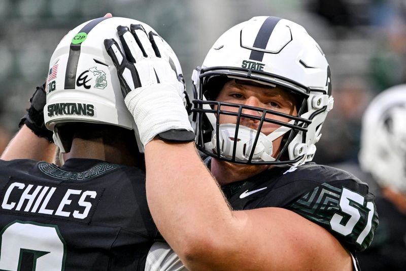 Michigan State's Matt Gulbin, right, hugs quarterback Aidan Chiles before the football game against Boston College on Saturday, Sept. 6, 2025, at Spartan Stadium in East Lansing.