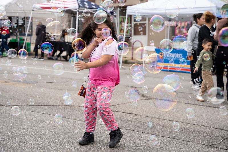 Amanda Aguilera, 7, plays with bubbles during Silver City Fest on Sept. 6, 2025, in Milwaukee, Wisconsin. The festival celebrated VIA CDC’s 30th anniversary and included live music, dancing, and food and merchandise from local vendors.
