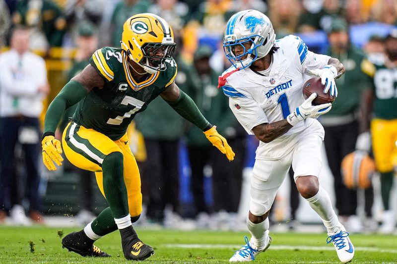 Detroit Lions wide receiver Jameson Williams (1) makes a catch against Green Bay Packers linebacker Quay Walker (7) during the second half at Lambeau Field in Green Bay, Wis., on Sunday, September 7, 2025.