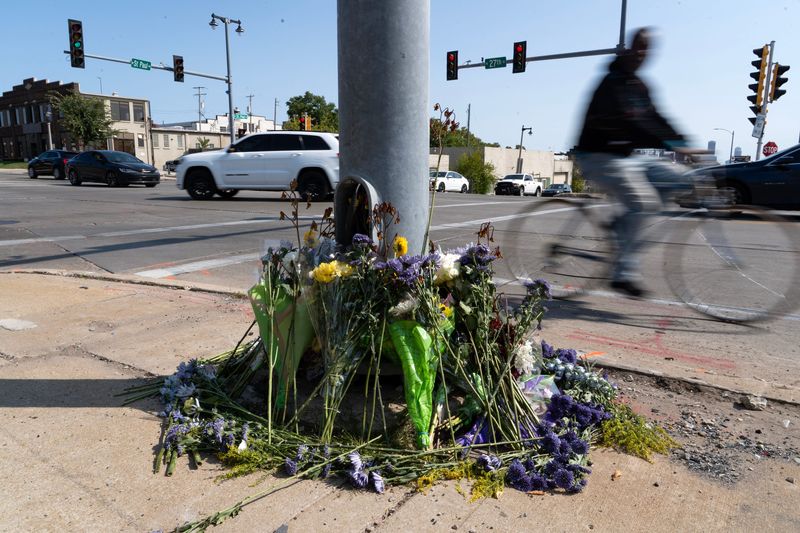 A memorial of flowers adorns the intersection of West St. Paul Avenue and North 27th Street, the site of a crash that killed two Marquette lacrosse players on Sept. 5.