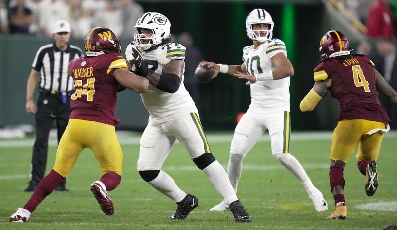 Jordan Morgan (77) provides pass protection for quarterback Jordan Love (10) against the Commanders. Morgan will anchor the left tackle position.