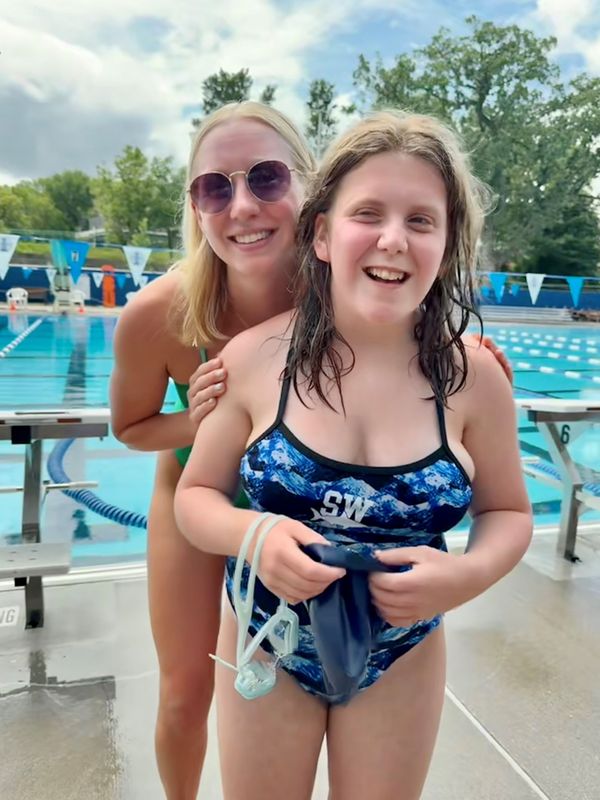 Aurelia Bergstrom (front) poses with former Madison West swimmer Natalie Shick, who served as Aurelia's age group coach in a summer swim league this past summer.
