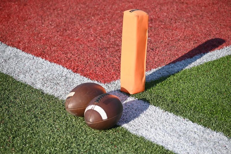Footballs sit on the field at East China Stadium in East China Township on Friday, Sept. 12, 2025.