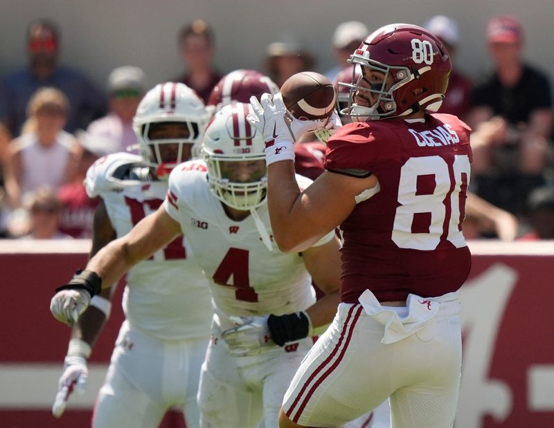 Sep 13, 2025; Tuscaloosa, Alabama, USA; Alabama tight end Josh Cuevas (80) catches a pass over the middle with Wisconsin linebacker Tackett Curtis (4) pursuing at Saban Field at Bryant-Denny Stadium. Mandatory Credit: Gary Cosby Jr.-Imagn Images