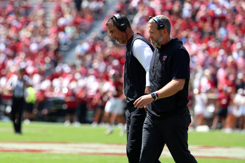 Sep 13, 2025; Tuscaloosa, Alabama, USA; Wisconsin Badgers head coach Luke Fickell converses with an assistant during the second quarter against the Alabama Crimson Tide at Saban Field at Bryant-Denny Stadium. Mandatory Credit: David Leong-Imagn Images