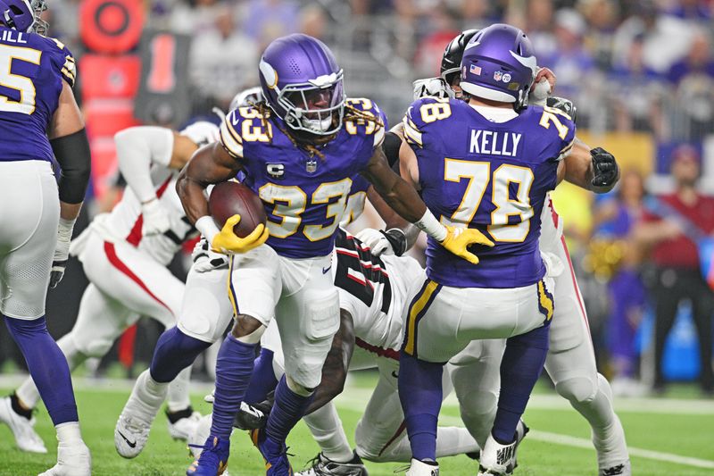 Sep 14, 2025; Minneapolis, Minnesota, USA; Minnesota Vikings running back Aaron Jones Sr. (33) runs the ball during the first half against the Atlanta Falcons at U.S. Bank Stadium. Mandatory Credit: Jeffrey Becker-Imagn Images