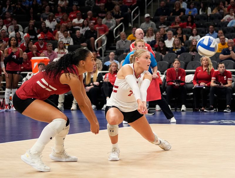 Wisconsin Badgers outside hitter Grace Egan (32) and libero/defensive specialist Kristen Simon (7) prepare to hit a bump during the first set of the match against the Marquette Golden Eagles on Wednesday September 17, 2025 at Fiserv Forum in Milwaukee, Wisconsin.