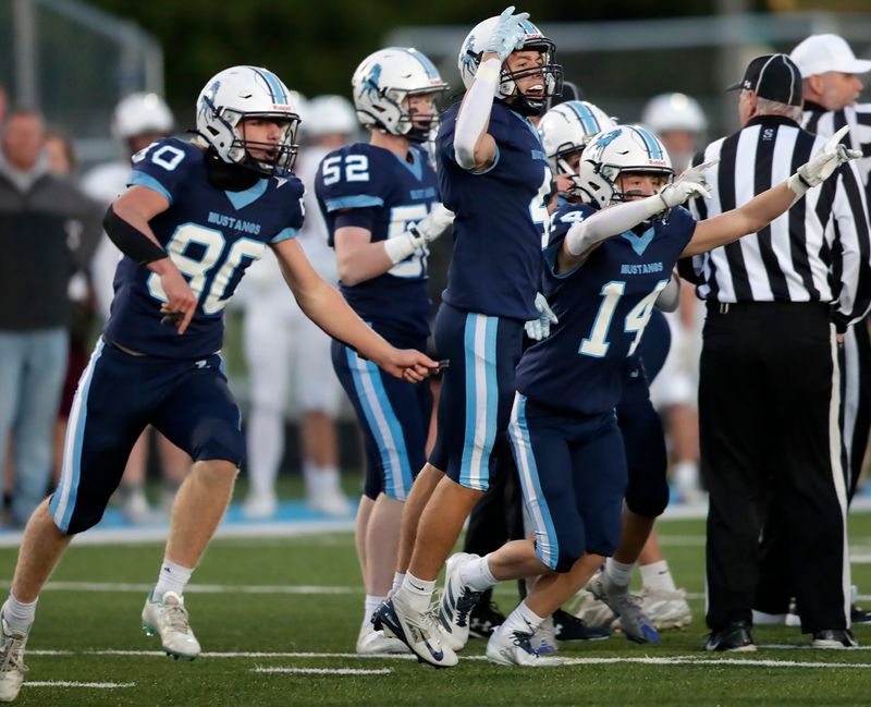 Little Chute football players celebrate a fumble recovery against Waupaca during a North Eastern Conference game Sept. 5 at Little Chute.