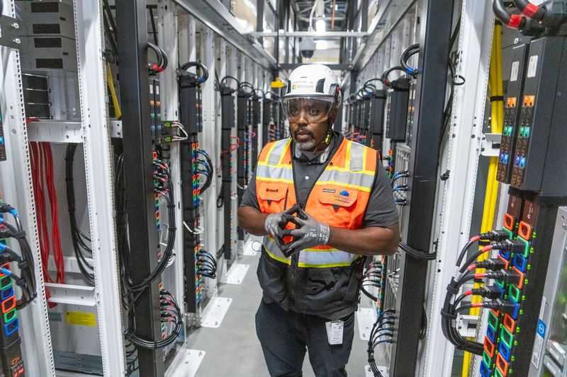 Derick Winston, a Microsoft senior operations director gives a tour of the data hall at the Microsoft data center in Mount Pleasant, Wisconsin on Sept. 18, 2025. Microsoft announced plans to spend $4 billion to build a second data center in Mount Pleasant that it says will be the most advanced AI center in the world.