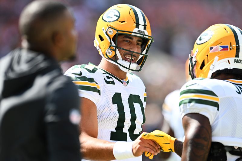 Sep 21, 2025; Cleveland, Ohio, USA; Green Bay Packers quarterback Jordan Love (10) shakes hand with running back Josh Jacobs (8) before the game between the Cleveland Browns and the Packers at Huntington Bank Field. Mandatory Credit: Ken Blaze-Imagn Images