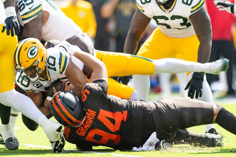 Green Bay Packers quarterback Jordan Love is sacked by Cleveland Browns defensive tackle Mason Graham and defensive tackle Maliek Collins.