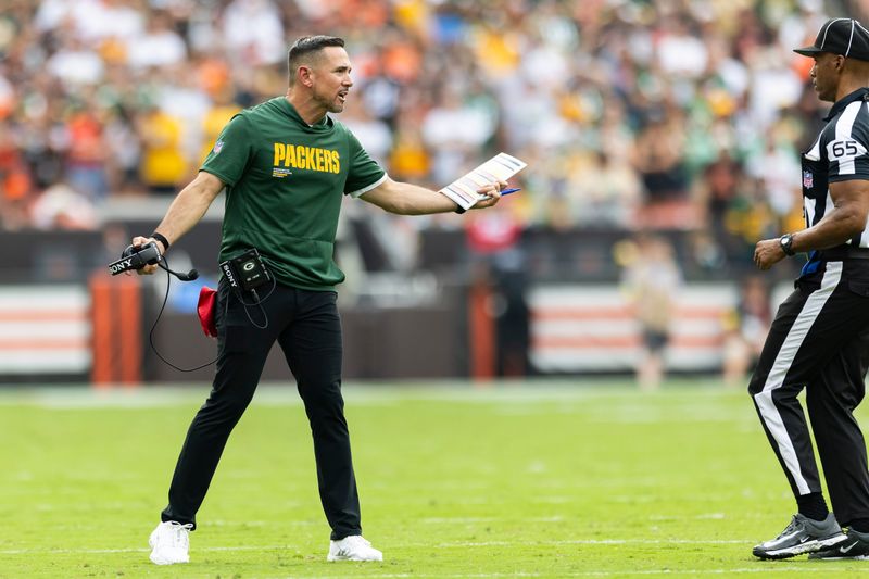 Sep 21, 2025; Cleveland, Ohio, USA; Green Bay Packers head coach Matt LaFleur argues a call with line judge Walt Coleman IV (65) during the fourth quarter at Huntington Bank Field. Mandatory Credit: Scott Galvin-Imagn Images