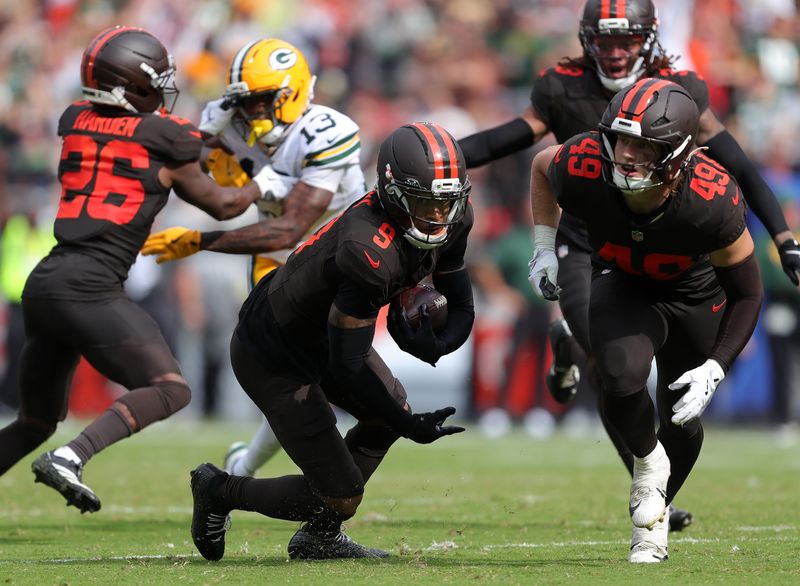 Cleveland Browns safety Grant Delpit (9) picks up yards after intercepting a pass thrown by Green Bay Packers quarterback Jordan Love (10) during the second half of an NFL football game at Huntington Bank Field, Sept. 21, 2025, in Cleveland, Ohio.