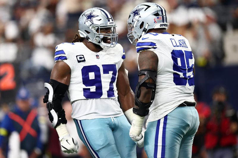 Sep 14, 2025; Arlington, Texas, USA; Dallas Cowboys defensive tackle Osa Odighizuwa (97) celebrates with defensive tackle Kenny Clark (95) after a play against the New York Giants during the second quarter at AT&T Stadium. Mandatory Credit: Kevin Jairaj-Imagn Images