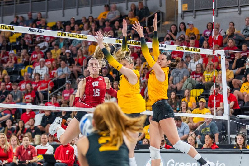 Iowa libero Milana Moisio attempts to dig Wisconsin outside hitter Mimi Colyer's attack in the Badgers' three-set win over Iowa at Xtream Arena in Coralville, Iowa, on Sept. 28, 2025.