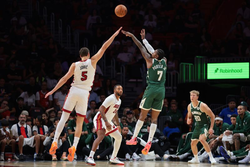 Bucks guard Kevin Porter Jr. shoots the ball against Heat forward Nikola Jovic during the second quarter at Kaseya Center.