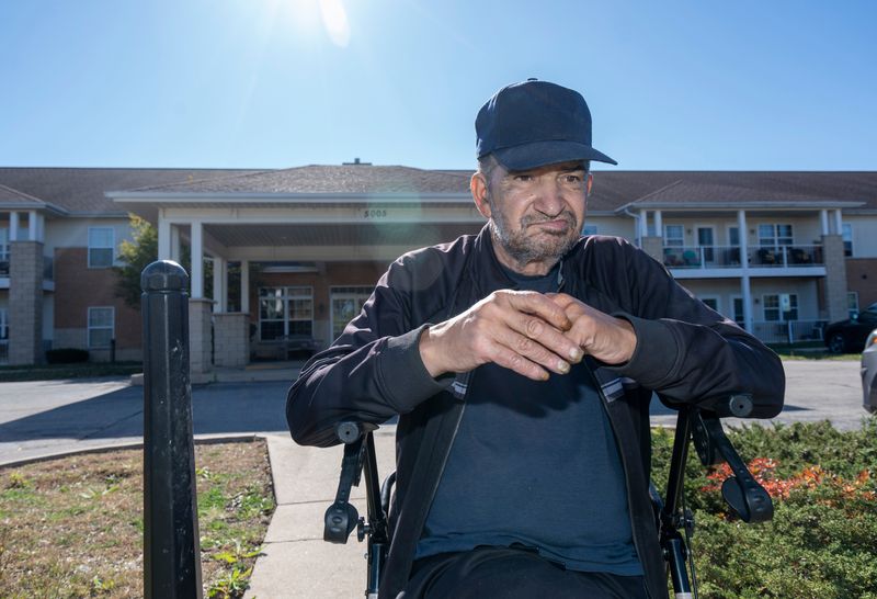 Michael Todorovich, a resident at Algonquin Manor, sits on his walker outside the senior facility on Oct. 8. The building in Brown Deer faced a possible power shutoff due to unpaid bills.