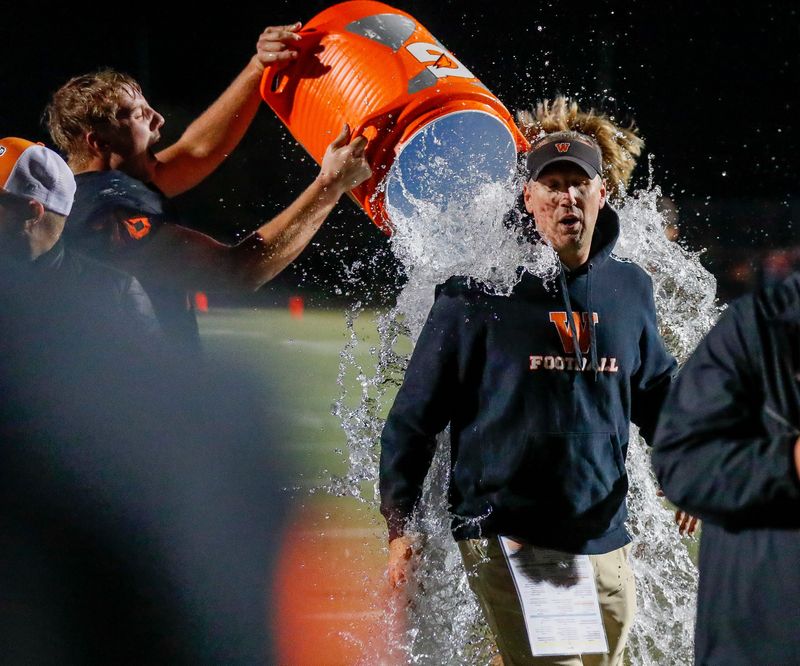 West De Pere players douse coach Chris Greisen after the team's 48-45 win over Bay Port earlier this season.